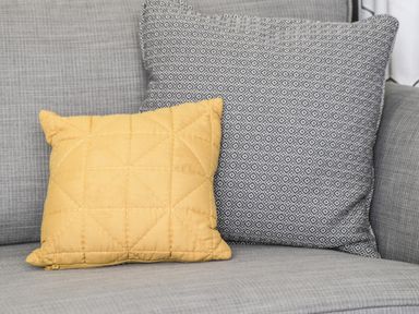 Two cushions on a grey fabric sofa at Finch 59 in Cayton