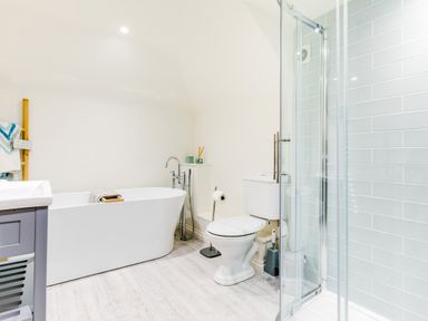 A bathroom with a bathtub toilet shower and vanity at Goose Cottage within the Helland Barton Farm collection in Delabole
