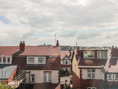 A view of red-roofed houses with chimneys under a cloudy sky at 41 Chatsworth Gardens in Scarborough