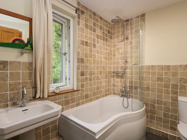 A bathroom with a bathtub shower combination sink and toilet at Fellside View in Chapel Stile