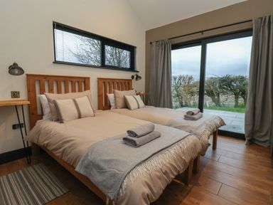 A bedroom with two single beds and folded towels on each bed at Skylark in Bishop Wilton