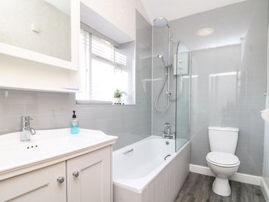 A bathroom with a bathtub shower combination sink with cabinet and toilet at Carvannel Cottages North Cliffs near Portreath
