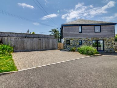 An outdoor area with a house and driveway at Sandy Cove, Praa Sands