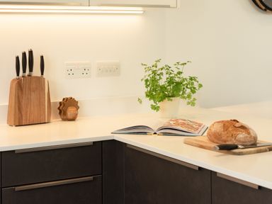 A kitchen with a knife block and a cutting board at Sandy Cove in Praa Sands