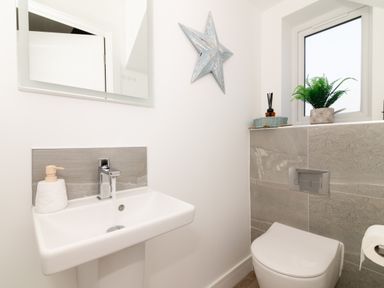 A bathroom with a sink and toilet at Sandy Cove in Praa Sands