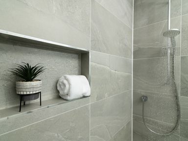 A shower area with a towel and a plant at Sandy Cove in Praa Sands