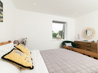 A bedroom with a bed and window at Sandy Cove, Praa Sands