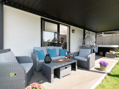An outdoor seating area with furniture at Sandy Cove in Praa Sands