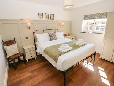 A bedroom with a bed with white linens and green throw at Catamouse in Milford Haven