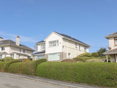 A residential street with detached houses and hedges at Awelfryn in Criccieth