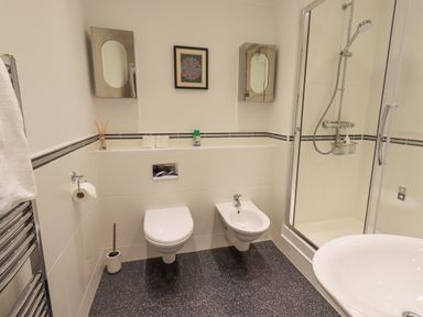 A bathroom with a toilet bidet shower area and sink at Beechside in Ambleside