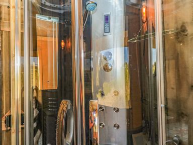 A shower cabin with controls and a handheld showerhead at Semira Tent Lodge in Blackawton