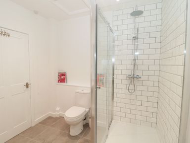 A bathroom with a shower enclosure and a toilet at Flodden in Crookham near Cornhill-On-Tweed