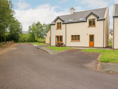 A semi detached house with a driveway and grass at 14 Sneem Leisure Village in Sneem County Kerry