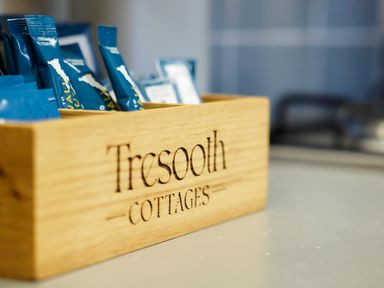 A wooden box with coffee sachets on a kitchen counter at Kerensa in Mawnan Smith Near Falmouth