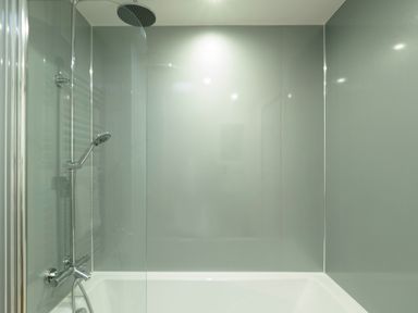 A bathroom with a bathtub and a shower head at Kerensa in Mawnan Smith Near Falmouth