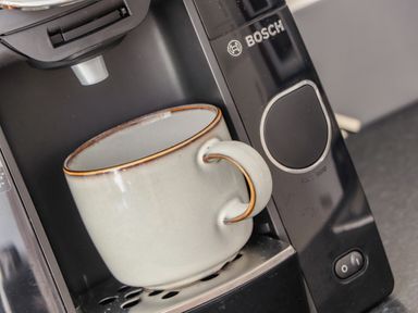 A coffee machine with a ceramic cup placed on the drip tray at Helford in Mawnan Smith Near Falmouth