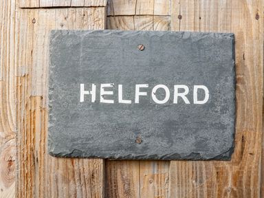 A slate sign with the word HELFORD mounted on a wooden surface at Helford Mawnan Smith Near Falmouth