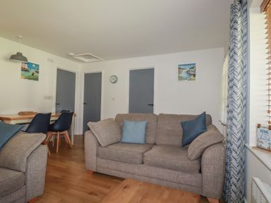 A living room with a sofa and dining table at Lilyvale Davidstow near Camelford