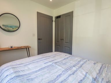 A bedroom with a bed and table at Lilyvale in Davidstow near Camelford