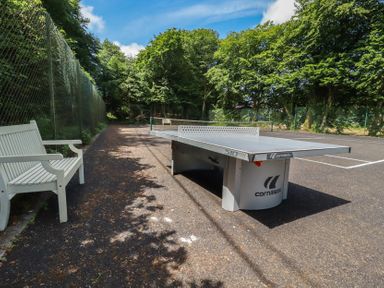 An outdoor area with a ping pong table and a bench at Lilyvale in Davidstow near Camelford