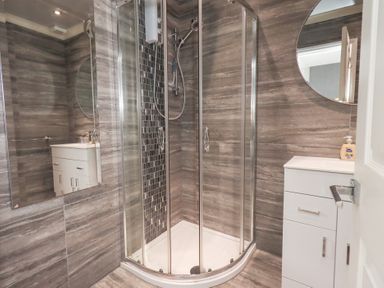 A bathroom with a shower and sink at Bowness Central Bowness-On-Windermere