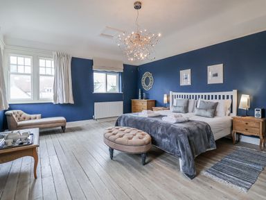 A bedroom with a bed and bedside tables at Holly Lodge in Aldeburgh