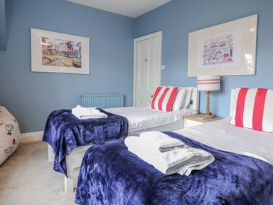 A bedroom with two beds and a lamp at Holly Lodge in Aldeburgh