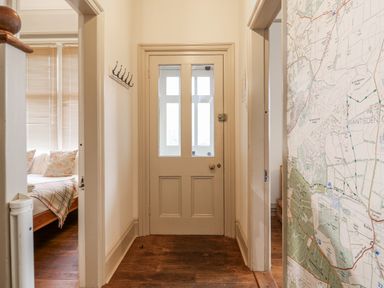 A hallway with a map on the wall at Holly Lodge in Aldeburgh