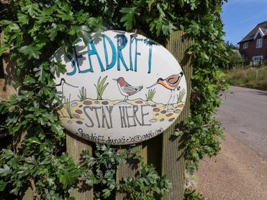 A sign with the text Seadrift Stay Here and illustrations of birds at Seadrift Dunwich Near Westleton
