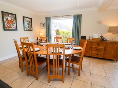 A dining room with a table set for dinner at Seadrift in Dunwich Near Westleton