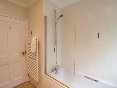 A bathroom with a bathtub and shower at Seadrift Dunwich Near Westleton