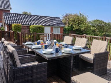 An outdoor dining area with a table set for breakfast at Seadrift Dunwich Near Westleton
