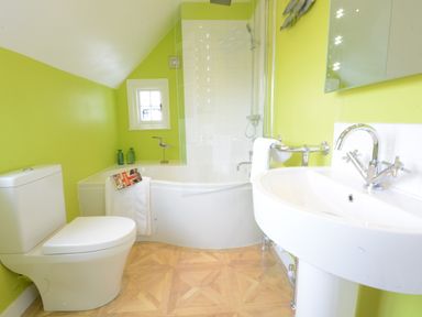 A bathroom with a toilet sink bathtub and shower at 4 The Dunes Thorpeness
