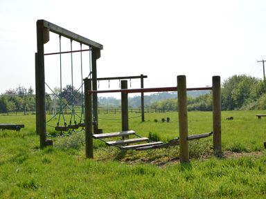 An outdoor wooden obstacle course with ropes and beams in a grassy field at 1 The Old Coach House Huntingfield Near Laxfield