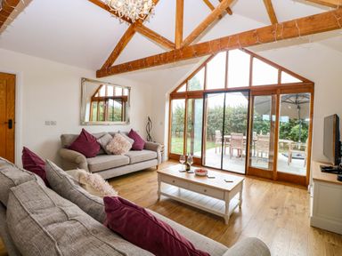 A living room with sofas and a coffee table at The Mulberry, nr Bungay