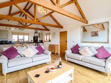A living room with a sofa and coffee table at The Mulberry, nr Bungay