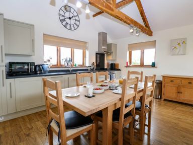 A kitchen with a dining table and chairs at The Mulberry, nr Bungay