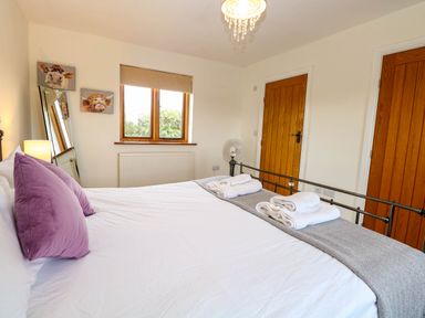 A bedroom with a bed and decorative items at The Mulberry, nr Bungay in Bungay
