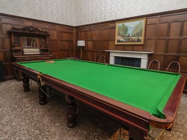 A game room with a snooker table and wall art at Henstead Hall Henstead near Beccles
