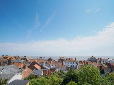 A coastal town with rooftops and the sea in the background at 10 Church Walk Aldeburgh