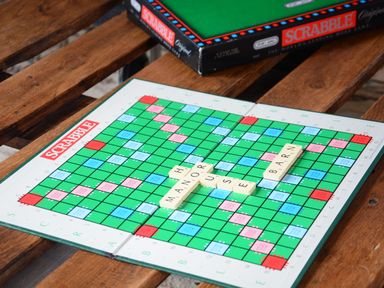 A Scrabble board with the words manor house barn on a wooden table at Manor House Barn Peasenhall
