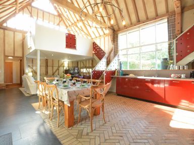 A kitchen with a dining table and chairs at Yew Tree Farm Barn and Stable Framlingham