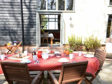 A dining table set with food and drinks outside at Yew Tree Farm Barn and Stable Framlingham