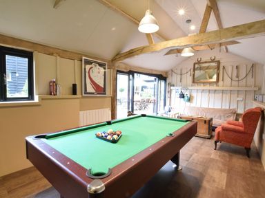 A games room with a pool table and seating at Yew Tree Farm Barn and Stable Framlingham