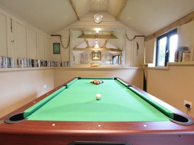 A game room featuring a pool table and a DVD collection at Yew Tree Farm Barn and Stable, Framlingham