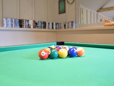 A pool table with billiard balls at Yew Tree Farm Barn and Stable Framlingham