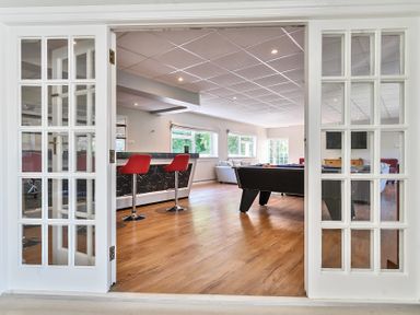 A games room with a pool table red bar stools and sofas at Bedingfield House nr Debenham Debenham 