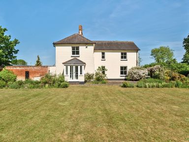 A white two-story house with a garden and lawn in front at Bedingfield House nr Debenham Debenham
