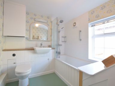 A bathroom with a toilet sink bathtub and shower at Seaflower Aldeburgh in Aldeburgh